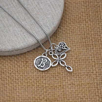 Collana cuore e croce con iniziale