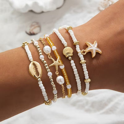Set di 6 bracciali da spiaggia dorati